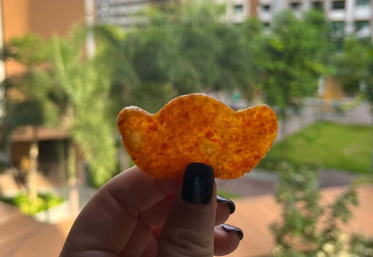 One pineapple crisp held up outdoors